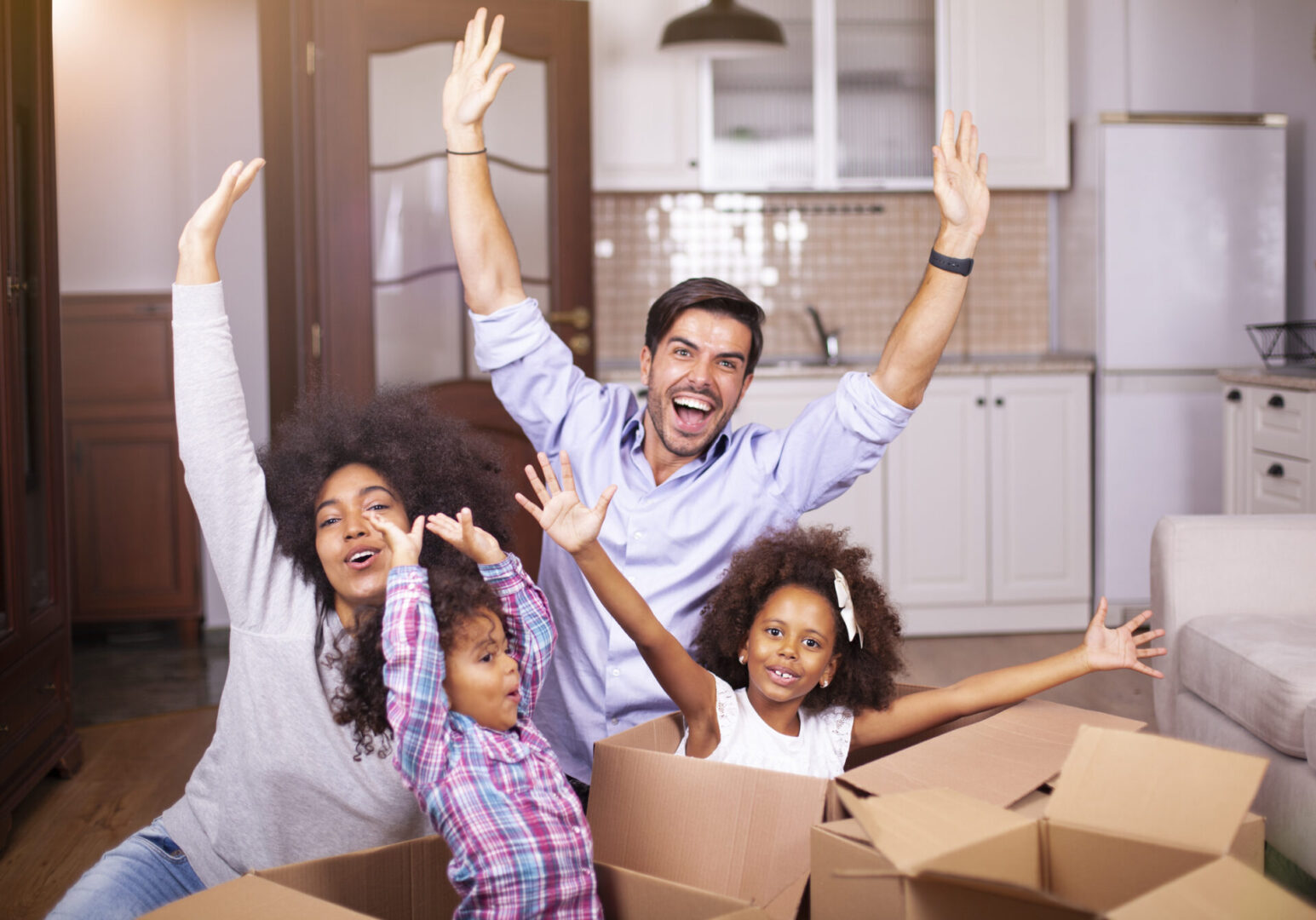 Young happy family moving into a new house.